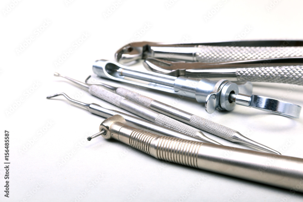 Set of metal medical equipment tools for teeth dental care on white background. Selective focus. Set of metal medical equipment tools for teeth dental care on white background. Selective focus.