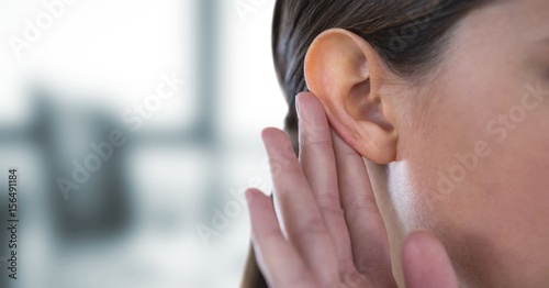 Tableau sur toile Cropped image of woman hearing gossip