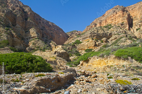 Dry riverbed in an eroded and rough landscape on the coast of Crete, Greece