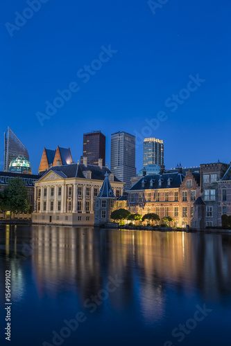 Binnenhof Palace of Parliament inThe Hague in The Netherlands Shot During Blue Hour Time. Against Modern Skyscrapers on Background.