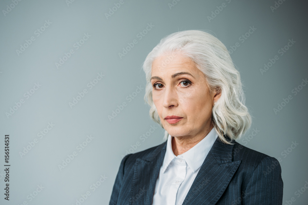portrait of confident senior businesswoman in suit isolated on grey portrait of confident senior businesswoman in suit isolated on grey