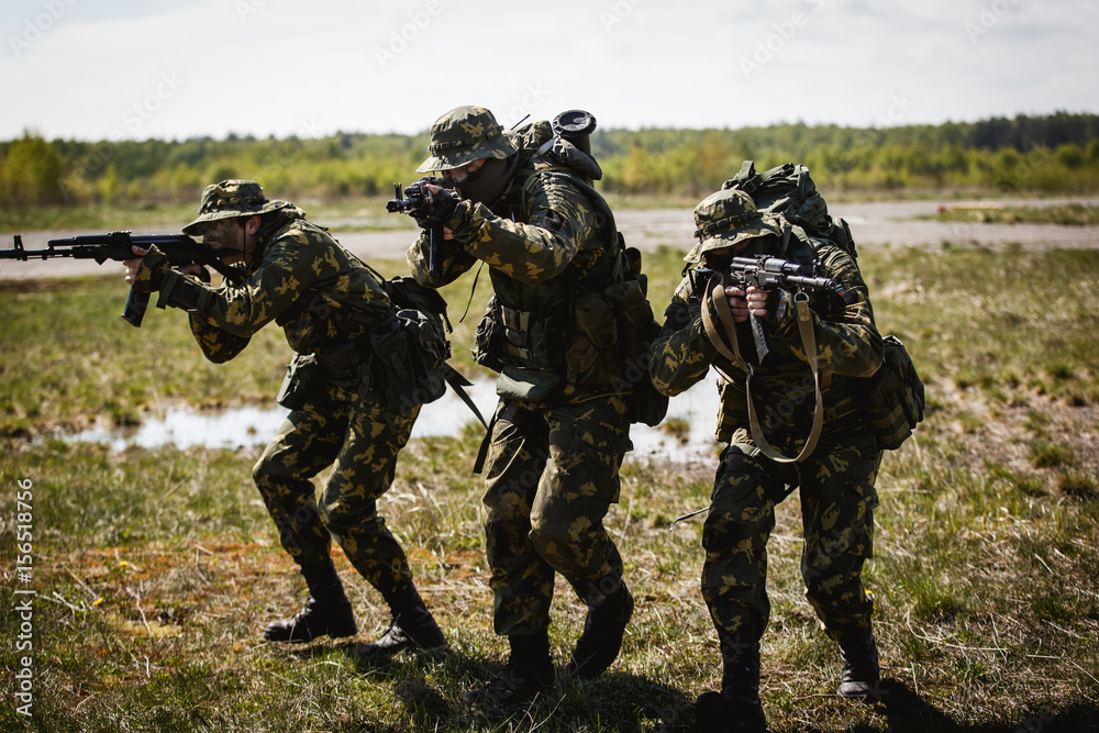 A group of special forces in a field with weapons A group of special forces in a field with weapons