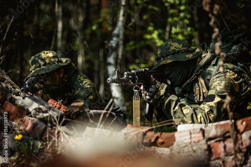 Military men with submachine gun © snedorez