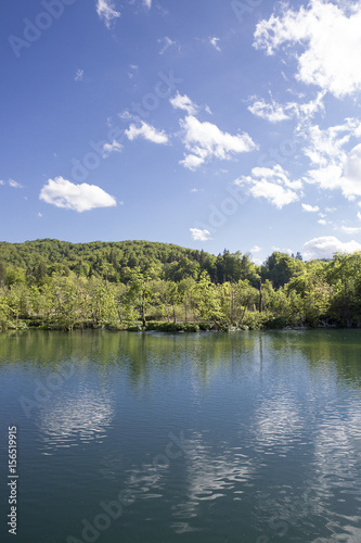 Landscape with beautiful luxuriant nature, lake and blue sky with clouds at "Plitvice Lakes" National Park, Croatia