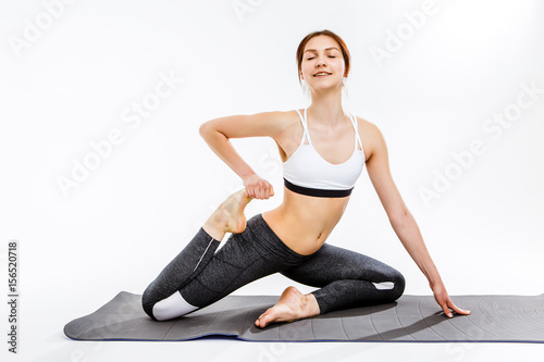Sportswoman doing exercises on rug