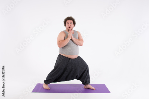 Funny fat man and yoga. Sport, diet and a healthy lifestyle.   © vladorlov