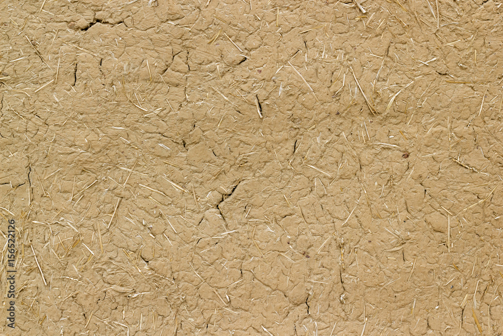 Old clay wall cracked straw background Old clay wall cracked straw background