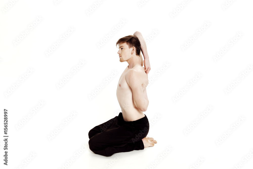 Young man doing yoga exercises. Studio shot on white background Young man doing yoga exercises. Studio shot on white background