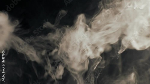 Vapor like smoke at sepia on a dark black background. Vape smoke rings in motion at vape clouds.