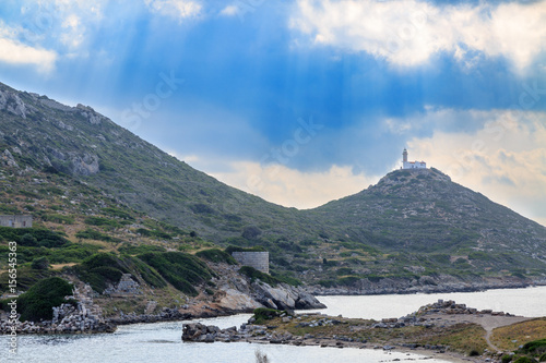 Lighthouse in knidos ancient greek city with sun rays in Datca, Turkey photo