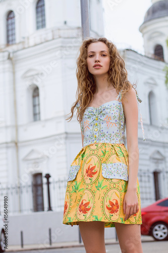 Beautiful and tall girl model appearance in stylish clothes walking around the city