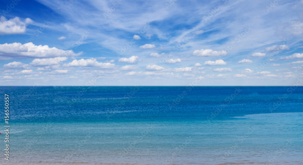 sandy beach shore with blue sea waters and cloudy sky banner