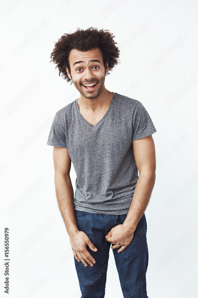 Surprised happy african man smiling looking at camera over white background. Surprised happy african man smiling looking at camera over white background.