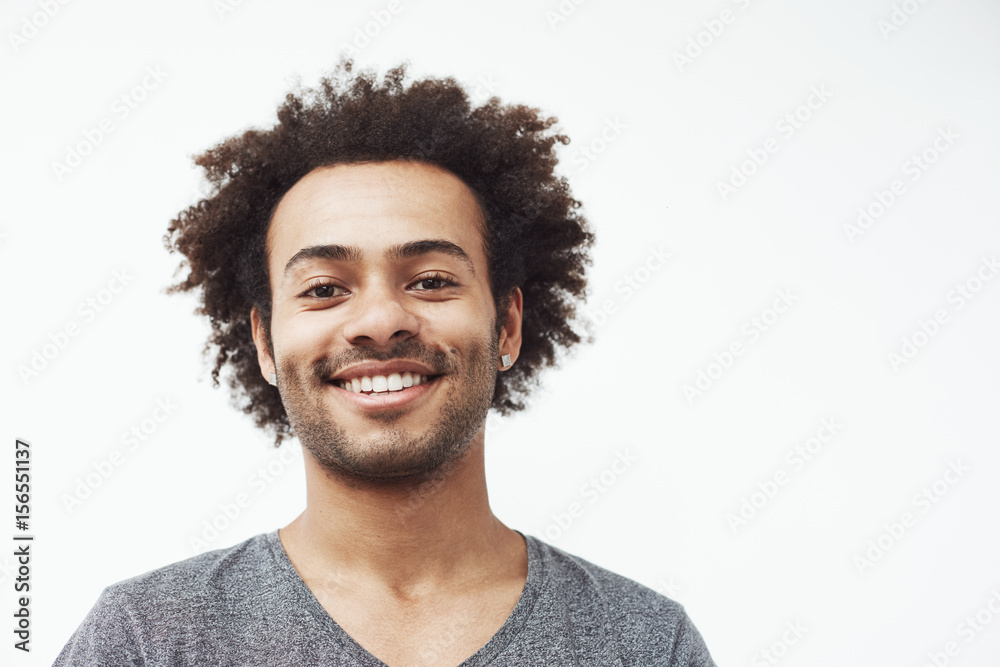 Happy african man smiling looking at camera. White background. Copy space. Happy african man smiling looking at camera. White background. Copy space.