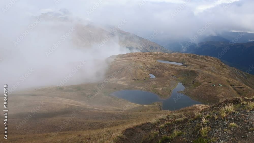 Rapid floating clouds over grassy autumn mountain hill timelapse. Amazing touristic place. Upper Svaneti, Mestia near Ushba pass. Georgia, Europe. HD video (High Definition). Rapid floating clouds over grassy autumn mountain hill timelapse. Amazing touristic place. Upper Svaneti, Mestia near Ushba pass. Georgia, Europe. HD video (High Definition).