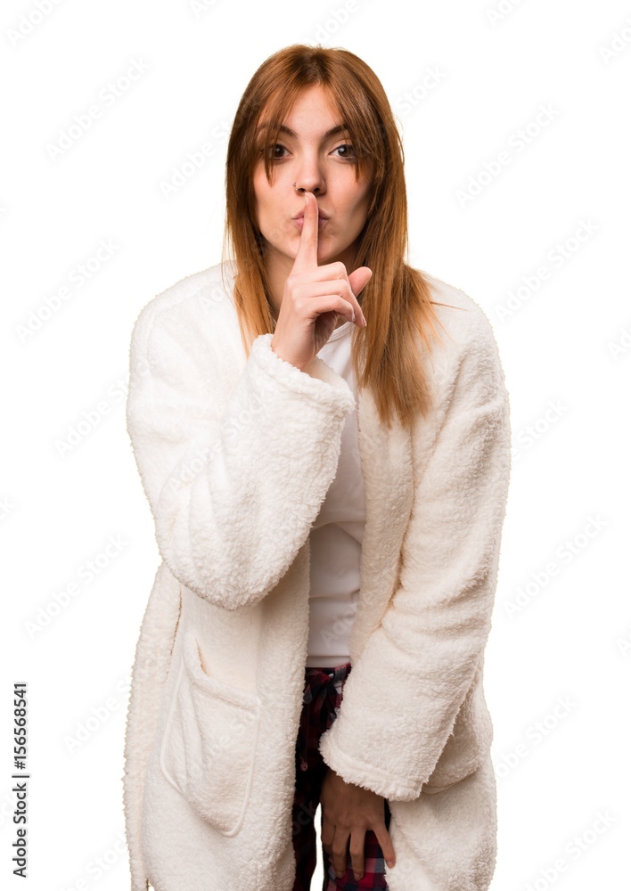 Young woman in dressing gown making silence gesture Young woman in dressing gown making silence gesture