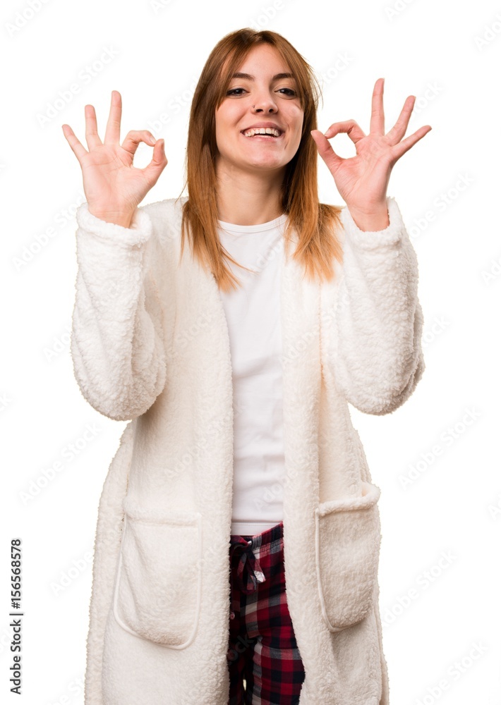 Young woman in dressing gown making OK sign Young woman in dressing gown making OK sign