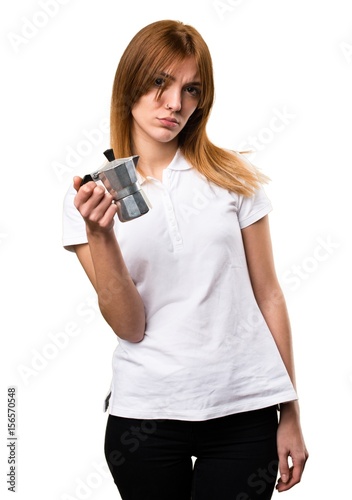 Beautiful young girl holding a coffee pot