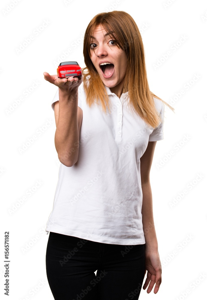 Surprised Beautiful young girl holding little car Surprised Beautiful young girl holding little car