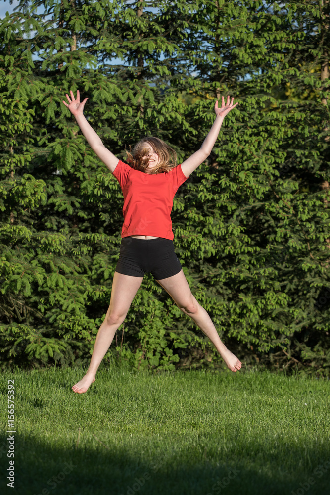 happy young woman is jumping
