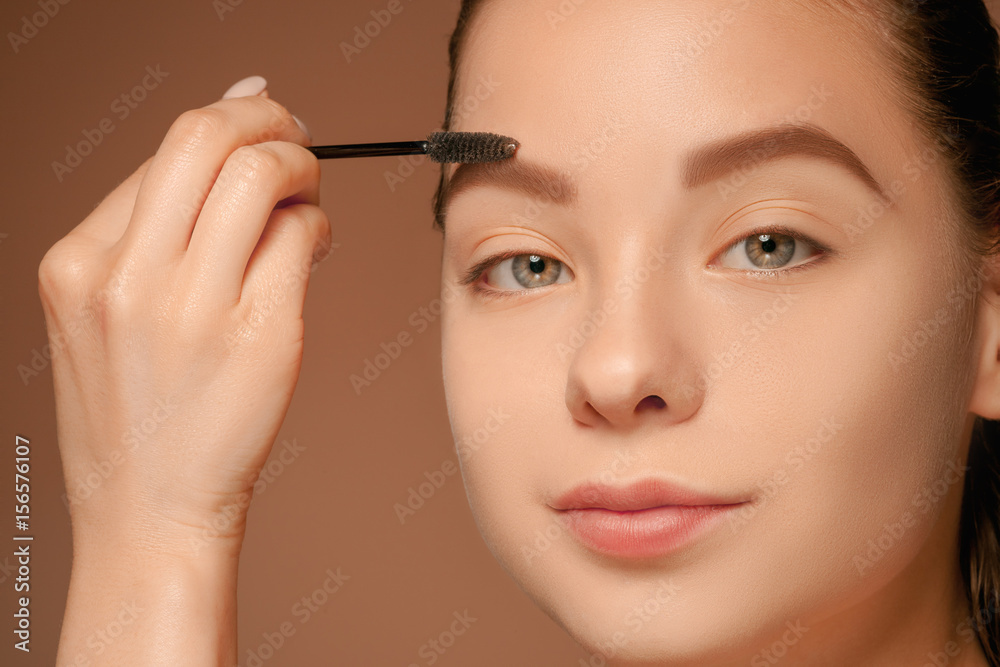 Beautiful female eyes with make-up and brush