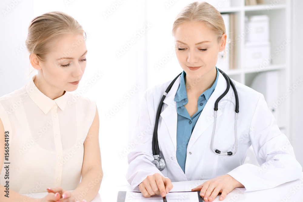 Doctor and patient sitting at the desk Doctor and patient sitting at the desk