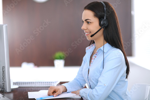Young business woman or student girl with headset in office
