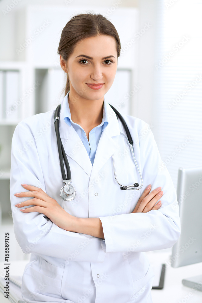 Latin american doctor woman standing with arms crossed and smiling at hospital. Physician ready to examine patient Latin american doctor woman standing with arms crossed and smiling at hospital. Physician ready to examine patient