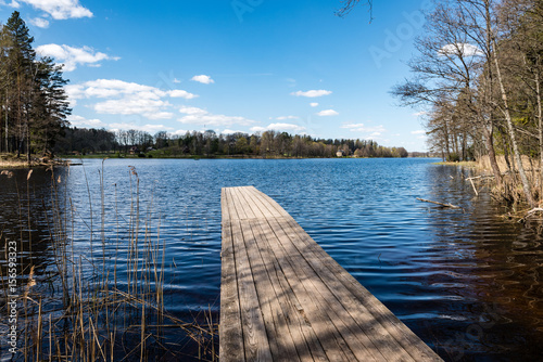 reflection of clouds in the lake with boardwalk