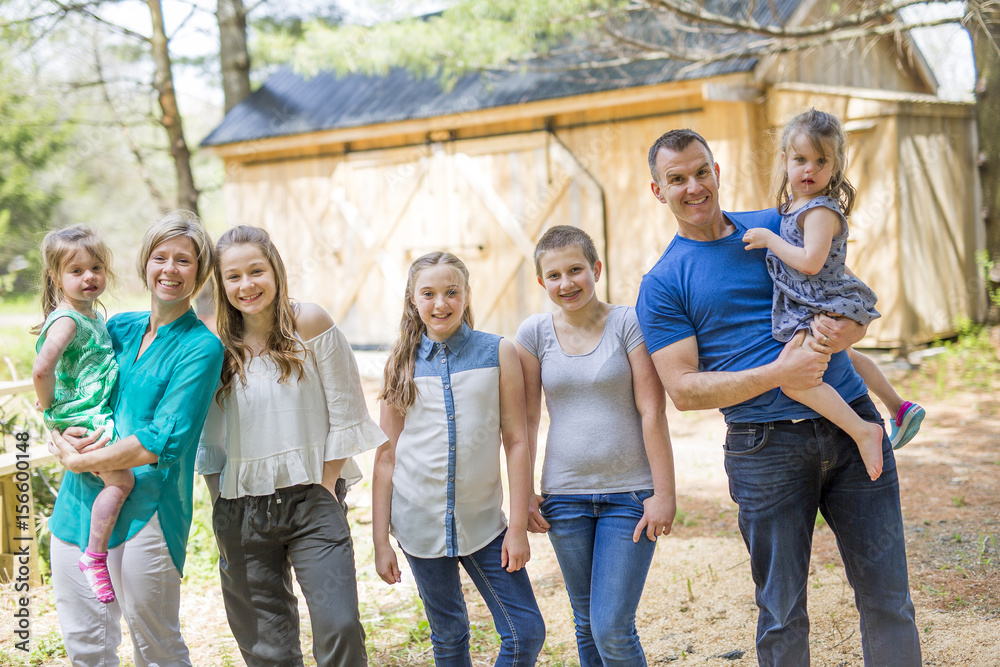 Obraz premium happy family in front of old barn.