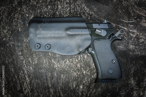 handgun in holster ready to firing position with safety on
