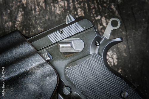 Fotografia handgun in holster ready to firing position with safety on