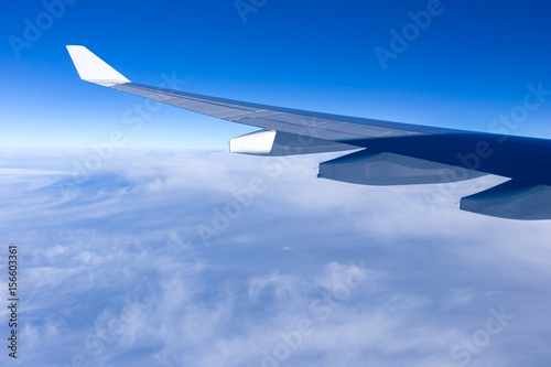 beautiful cloudy sky and airplane wing sky on sunny day, aerial view from airplane window, filter effect