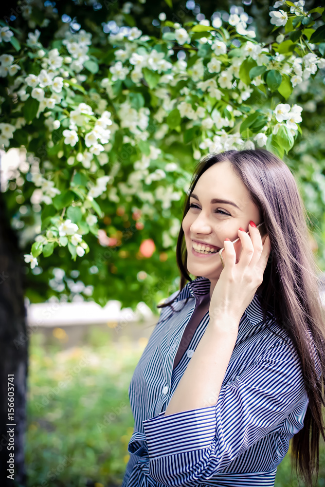 Beautiful girl speaks by phone and laughs Beautiful girl speaks by phone and laughs