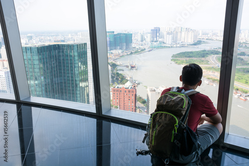 A man sitting to see a view ho chi min city at Vietnam