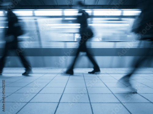 Subway train leaving station. People coming to or leaving the platform. Motion blur. Cyanotype effect. © Tata Chen