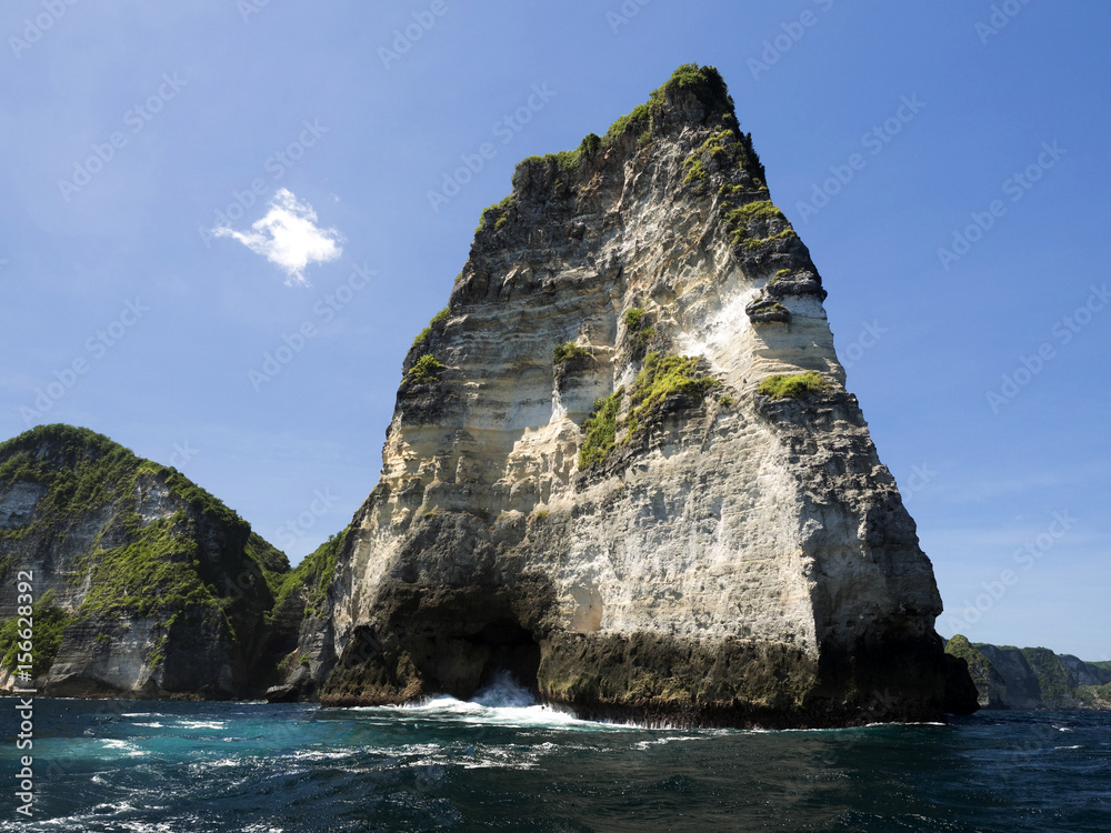 Limestone rocks covered with greenery, west coast of Penida island, Indonesi