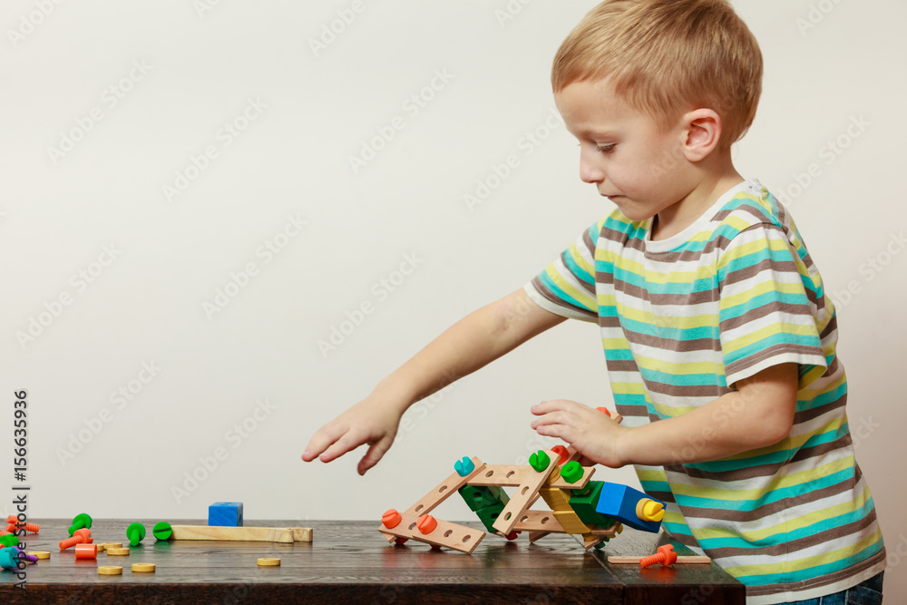 Little boy playing with toys having fun