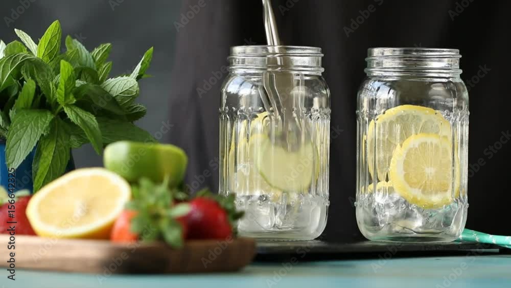 Homemade lemonade with lemon ,lime,mint and ice cubes on black background