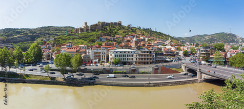 Panorama view of Tbilisi, capital of Georgia country. Landmarks - Narikala fortress, cable road above tiled roofs, Meidan square. photo