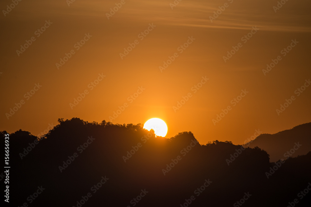 Sun rising from behind the mountain