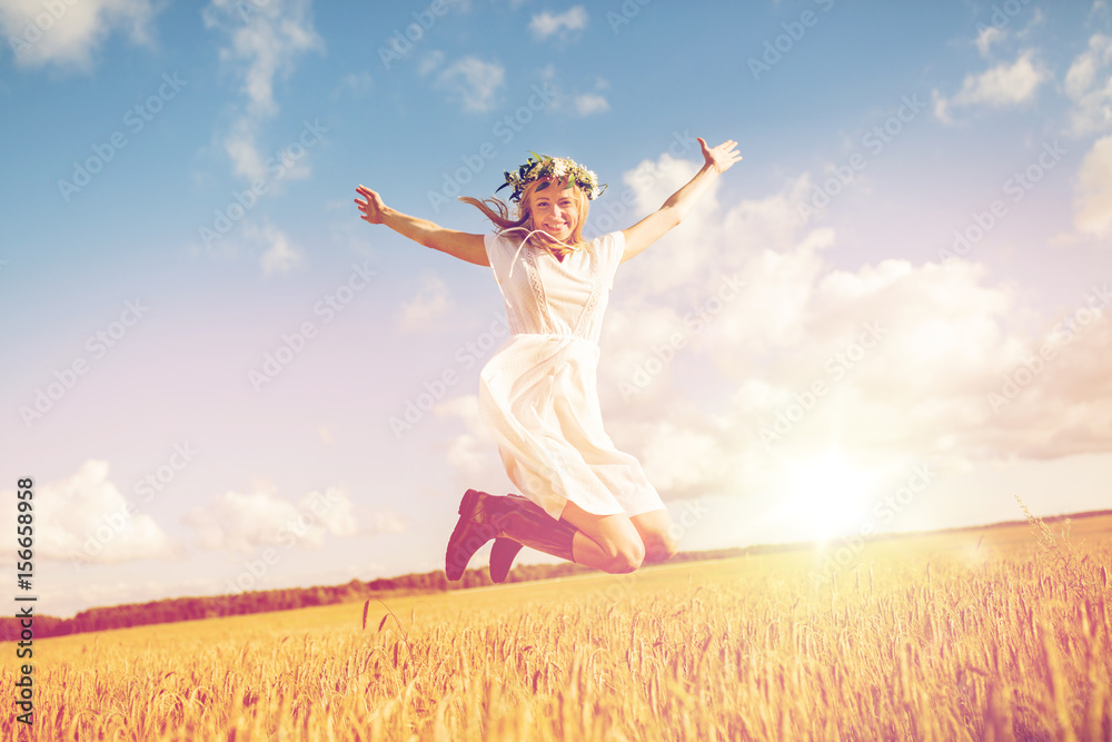 happy woman in wreath jumping on cereal field happy woman in wreath jumping on cereal field