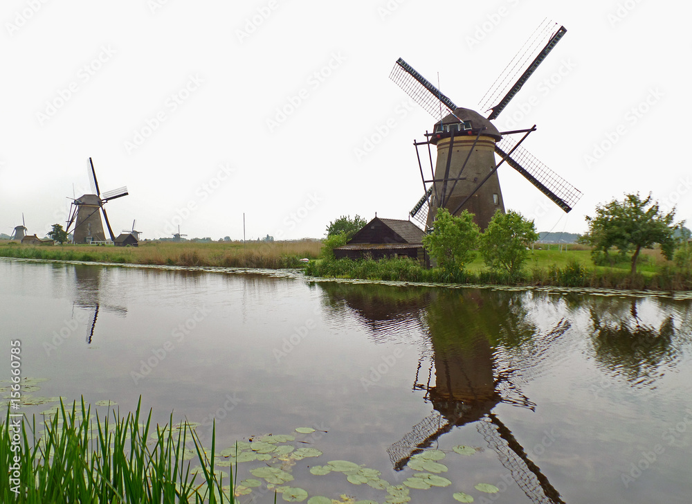 Reflections of Historic Windmills at Kinderdijk Mill Complex, UNESCO World Heritage Site in The Netherlands