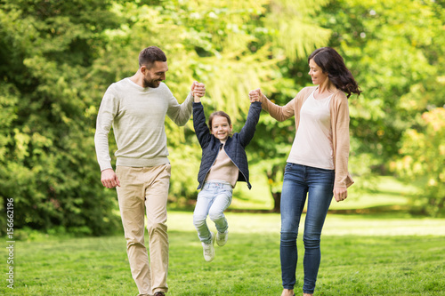 happy family walking in summer park and having fun