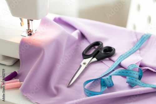 sewing machine, scissors, tape measure and fabric