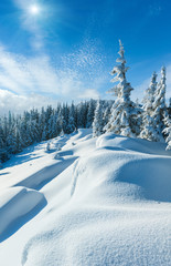 Snowdrifts on winter snow covered mountainside