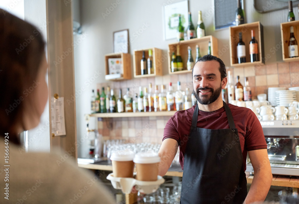 man or waiter serving customer in coffee shop