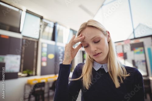 Sad school teacher in classroom