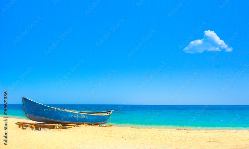Fishing boat on tropical sand beach with single cloud