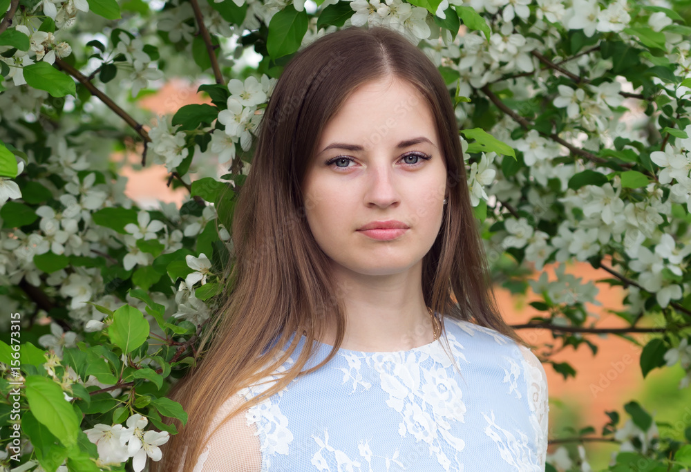 Girl posing against a background of flowering trees / Photographed in Russia, in the city of Orenburg Girl posing against a background of flowering trees / Photographed in Russia, in the city of Orenburg